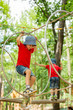 © Tomsickova - Cute child, boy, climbing in a rope playground structure