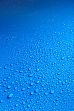Shiny Blue Smooth Surface Covered With Dew Drops