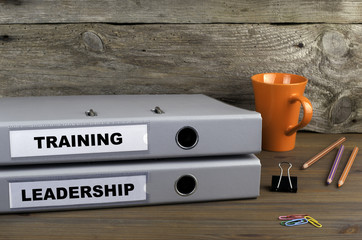 Wall Mural - Training and Leadership - two folders on wooden office desk
