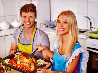 Happy family cooking chicken at kitchen. First cooking at home kitchen.