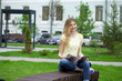 © Andrey_Arkusha - Young beautiful girl sitting on a bench in the summer park
