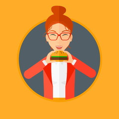 Canvas Print - Woman eating hamburger.