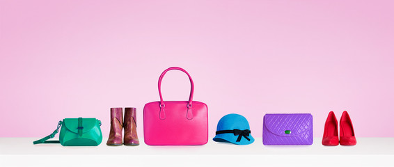 colorful hand bags,purse,shoes, and hat isolated on pink background. woman fashion accessories items