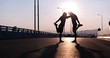 © Myvisuals - Silhouette of a fitness couple profile stretching at sunset with