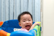 © Kenishirotie - Asian baby in playpen