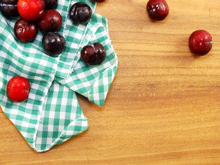 Canvas Print - red plum on wooden background top view