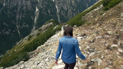 young woman hiking in mountains, super slow motion 240fps