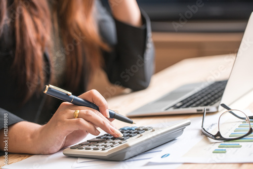 Cuadros en Lienzo Close up of female accountant or banker making calculations. Sav