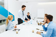 © djile - Young business people having a meeting in a conference room