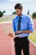 © WavebreakMediaMicro - Businessman using a laptop on the running track