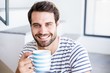 © WavebreakmediaMicro - Portrait of happy man having cup of coffee