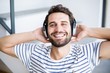 © WavebreakmediaMicro - Man relaxing and listening to music on headphone