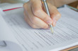 © jannoon028 - Hand with pen over application form .