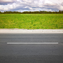 Empty Highway Roadside With Green Grass
