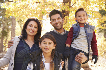 Portrait of Hispanic family outdoors looking at camera