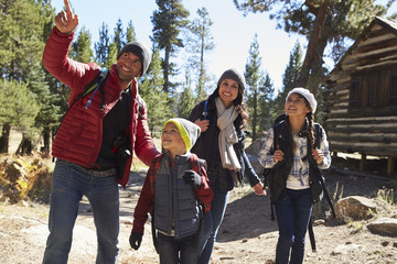 Wall Mural - Father pointing something out to his family during a hike