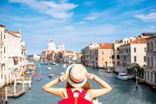 View On Grand Canal With Woman Traveler In Hat On Academia Bridge In Venice. Back View With Copy Space