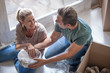 © Connect Images - Moving house: couple wrapping glassware in paper before packing