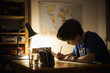 © fStop - Teenage boy studying at table in house