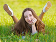 © stebliuk - Pretty young woman laying in the grass and smiling