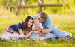 © lashkhidzetim - Happy family  having fun outdoors in spring field. Summer photo.Blurred background.
