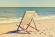 © aquar - Deckchair and female hat on stunning tropical beach vacation background