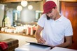 © WavebreakmediaMicro - Pizza delivery man taking an order over the phone