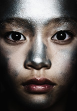 Portrait Of A Teenage Girl With Silver Paint On Her Face
