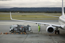 An Airplane Being Refueled On The Tarmac