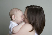 Portrait Of A Mother Kissing A Baby