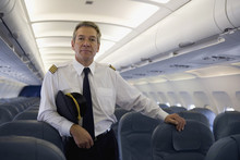 A Pilot Standing In The Cabin Of A Plane