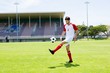 © WavebreakMediaMicro - Football player juggling the football with his feet