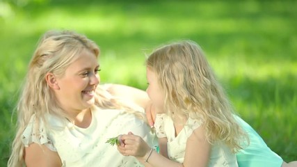 young pregnant mother plays with her daughter. happy family.