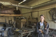 © fStop - Portrait of confident female mechanic with arms crossed at repair shop
