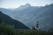 © fStop - Woman jogging on path in mountain range