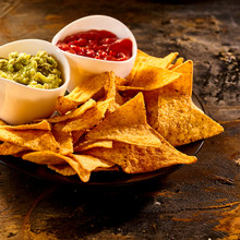 Plate Full Of Guacamole, Salsa And Nacho Chips