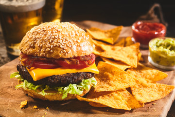 Burger with beer and nachos appetizers