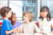 © jovannig - Group of multi ethnic elementary students working with tablet at