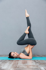 Poster - Yong healthy woman doing yoga sarvangasana