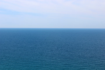 Blue sea waters and clear blue sky horizon