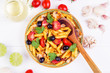 Classic Italian food - pasta with ingredients on a white wooden background
