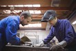 © Wavebreak Media - Tradesmen working together
