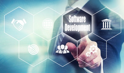 Businessman pushing a software development concept button.