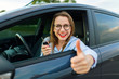 © vladstar - Young happy woman sitting in a car with the keys in her hand and