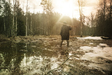 Young Man In Swamp In Winter