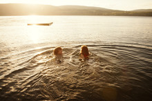 Boy And Girl Swimming In Lake