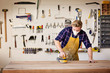 © Cavan Images - Carpenter sanding wood with sander in workshop
