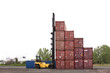 © Cavan Images - Forklift transporting cargo container in shipyard