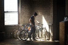 Man Parking Bicycle In Bike Rack