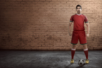 Poster - Asian football player standing on the alley